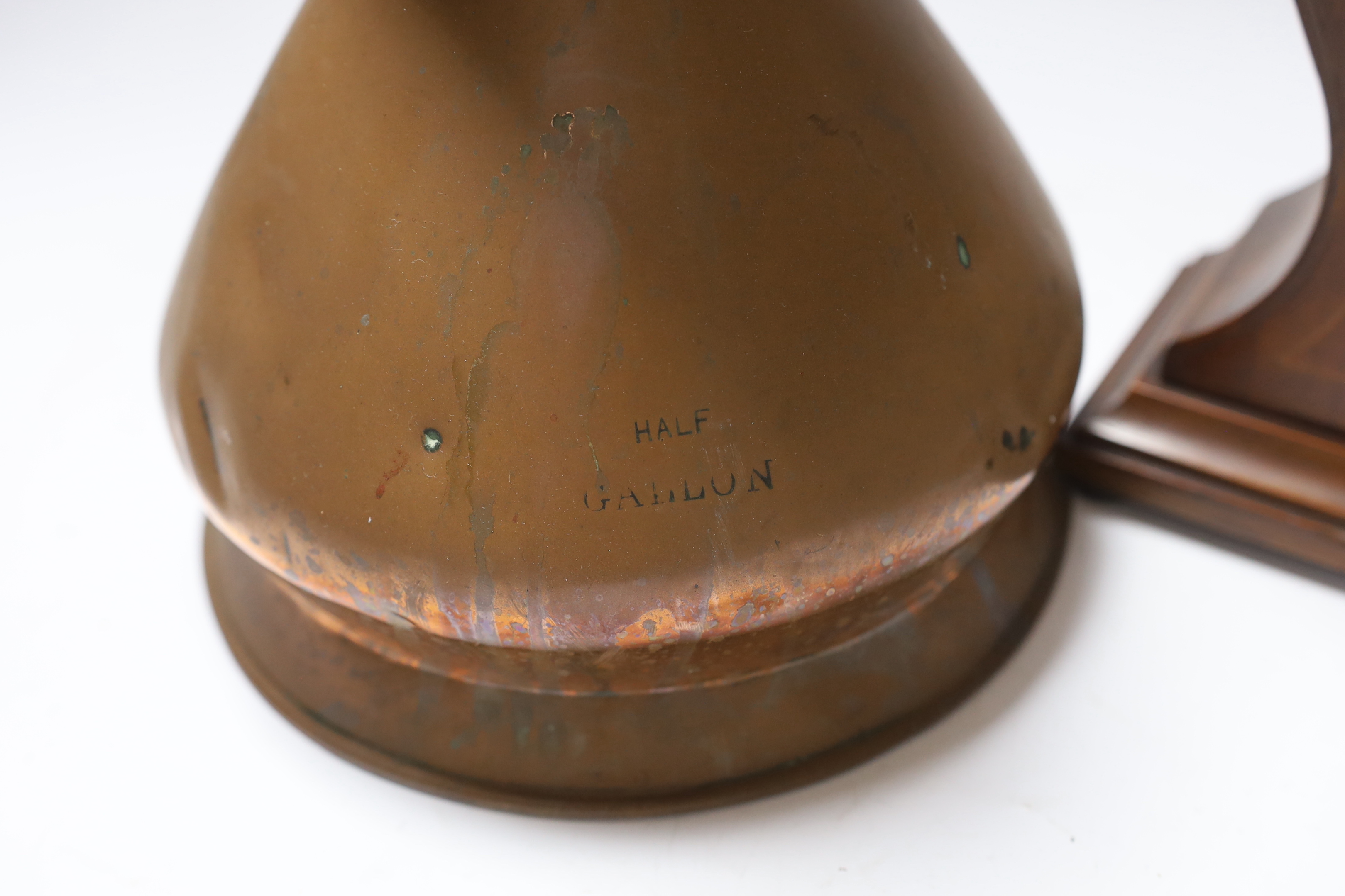 A copper measure jug and a mantel clock